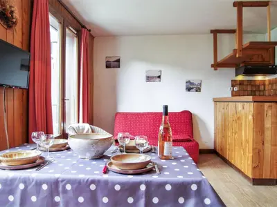 a bedroom with two bunk beds and a chair at Apartment l'Armancette by Interhome in Chamonix-Mont-Blanc