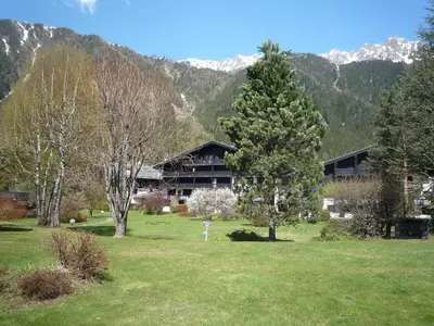 a building in the middle of a field with trees at Apartment Champraz-7 by Interhome in Chamonix-Mont-Blanc