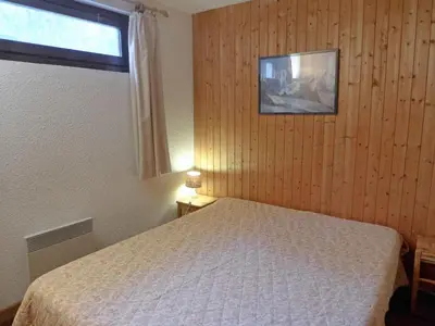 a bedroom with a bed and a window at Apartment Champraz-7 by Interhome in Chamonix-Mont-Blanc
