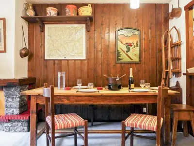 a room with a wooden table with two chairs at Apartment Champraz-7 by Interhome in Chamonix-Mont-Blanc