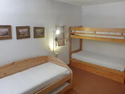 a bedroom with two bunk beds and a lamp at Apartment Champraz-7 by Interhome in Chamonix-Mont-Blanc