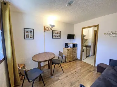 a living room with a table and chairs and a couch at Apartment Le Choucas by Interhome in Chamonix-Mont-Blanc