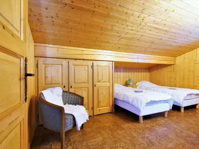 a dining room with a wooden table and chairs at Chalet Pierre Blanche by Interhome in Servoz
