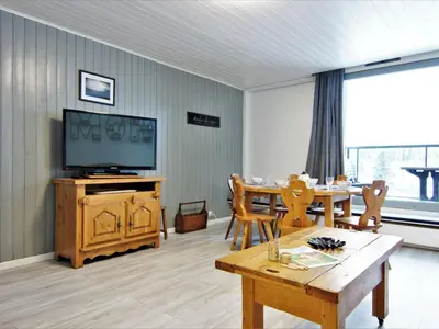 a building with snow capped mountains in the background at Apartment L'Outa by Interhome in Chamonix-Mont-Blanc