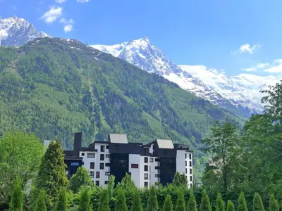 a bedroom with a bed with a clock on the wall at Apartment L'Outa by Interhome in Chamonix-Mont-Blanc