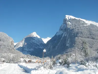 a snow covered mountain with a town in the foreground at Multi résidences Samoëns in Samoëns