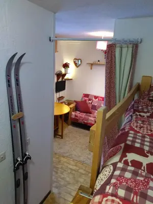 a room with a bed and a living room at Multi résidences Samoëns in Samoëns