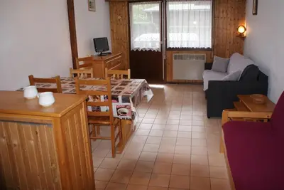 a living room with a couch and a table at Multi résidences Samoëns in Samoëns