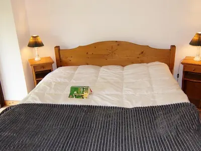 a bed with acomputer on top of it at Apartment Grand Roc-3 by Interhome in Chamonix-Mont-Blanc