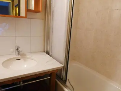 a bathroom with a sink and a bath tub at Apartment Grand Roc-3 by Interhome in Chamonix-Mont-Blanc