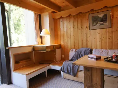 a room with a bed and a table and a window at Apartment Grand Roc-3 by Interhome in Chamonix-Mont-Blanc