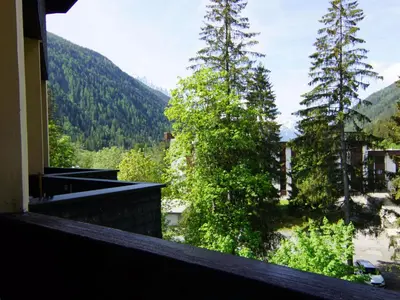 a view from the balcony of a house with mountains at Apartment Grand Roc-3 by Interhome in Chamonix-Mont-Blanc
