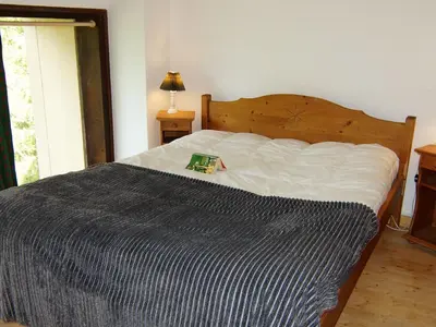 a bedroom with a bed with a book on it at Apartment Grand Roc-3 by Interhome in Chamonix-Mont-Blanc