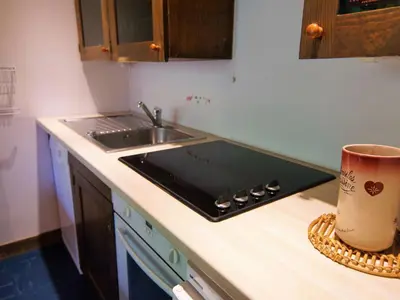 a kitchen counter with a sink and a mug on the counter at Apartment Grand Roc-3 by Interhome in Chamonix-Mont-Blanc