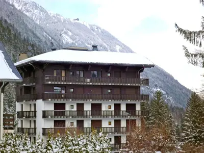 a building in front of a mountain with snow at Apartment Les Aiguilles du Brévent by Interhome in Chamonix-Mont-Blanc