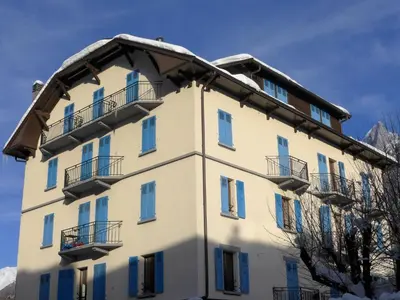 a building with blue windows and a mural on it at Apartment Le Savoisien by Interhome in Chamonix-Mont-Blanc