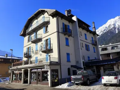 a large white building with balconies on a street at Apartment Le Savoisien by Interhome in Chamonix-Mont-Blanc