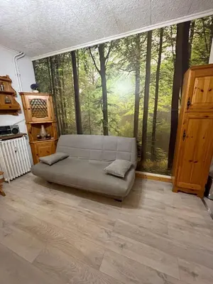 a small kitchen with a black tiled wall at Apartment Le Savoisien by Interhome in Chamonix-Mont-Blanc
