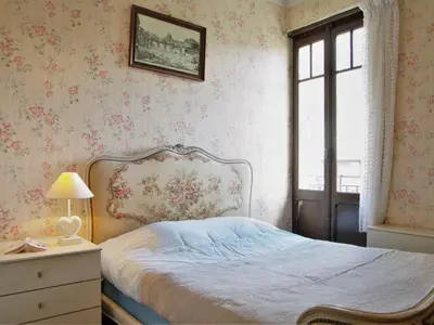 a bedroom with a bed and a dresser and a window at Apartment Le Savoisien by Interhome in Chamonix-Mont-Blanc