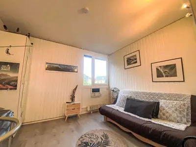 a living room with a couch and a window at Studio Arve 1 et 2-3 by Interhome in Chamonix-Mont-Blanc