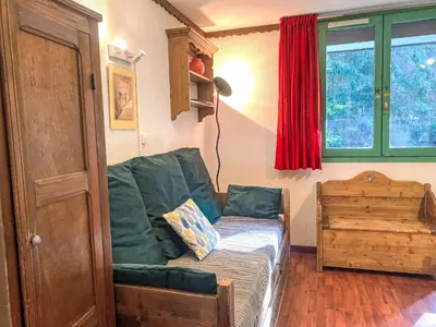 a living room with a green couch and a window at Studio Le Grépon-3 by Interhome in Chamonix-Mont-Blanc