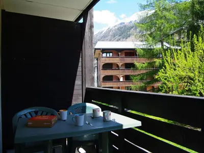 a table and chairs on a balcony with a view at Studio Le Grépon-3 by Interhome in Chamonix-Mont-Blanc