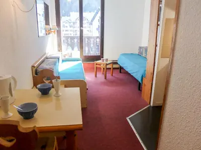 a room with a bed and a desk and a table at Apartment La Forclaz-2 by Interhome in Chamonix-Mont-Blanc