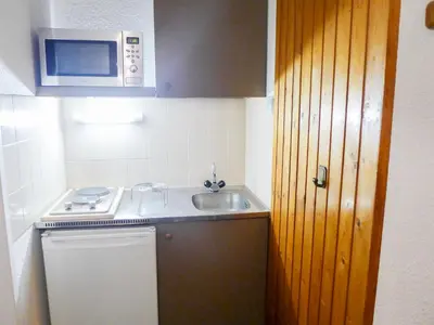 a small kitchen with a sink and a microwave at Apartment La Forclaz-2 by Interhome in Chamonix-Mont-Blanc