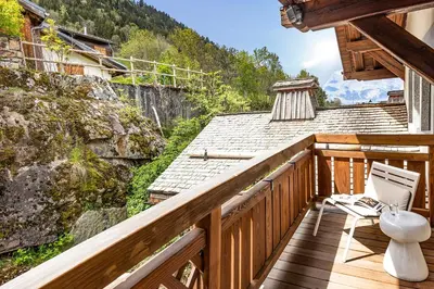 a restaurant with white tables and umbrellas at Armancette - The Leading Hotels of the World in Saint-Gervais-les-Bains