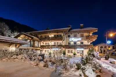 a large building in the snow at night at Armancette - The Leading Hotels of the World in Saint-Gervais-les-Bains