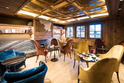 a bedroom with a large bed with two lamps at Armancette - The Leading Hotels of the World in Saint-Gervais-les-Bains