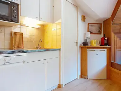 a room with a bed with a tray on it at Apartment Pierres Blanches F et H-20 by Interhome in Le Cugnon