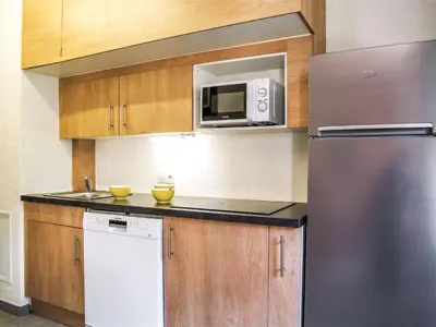 a kitchen with a refrigerator and a microwave at Apartment Gentiane-3 by Interhome in Chamonix-Mont-Blanc