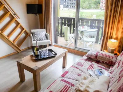 a living room with a couch and a table at Apartment Clos du Savoy-15 by Interhome in Chamonix-Mont-Blanc