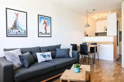 a living room with a couch and a table at Apartment Chamois Blanc 7A - Great views of Chamonix in Chamonix-Mont-Blanc
