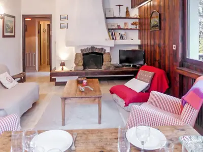a living room with a couch and a fireplace at Apartment Le Brévent-14 by Interhome in Chamonix-Mont-Blanc