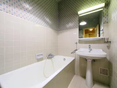a bathroom with a sink and a bath tub and a sink at Apartment Le Brévent-14 by Interhome in Chamonix-Mont-Blanc