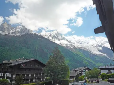a view of a snow covered mountain with a building at Apartment Le Brévent-14 by Interhome in Chamonix-Mont-Blanc