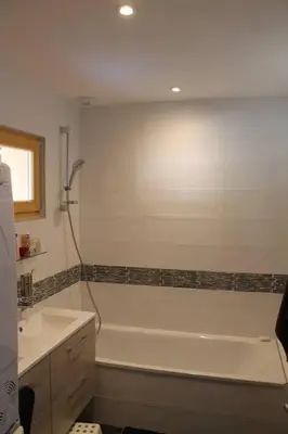 a bathroom with a bath tub and a sink at Chalet Les Contamines in Les Contamines-Montjoie