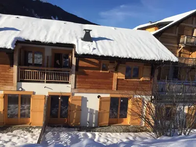 a snow covered house with a snow covered roof at Chalet Les Contamines in Les Contamines-Montjoie