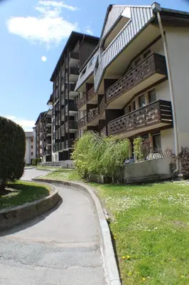 a building with a curvy sidewalk next to a building at Apartment Grepon 2 - A Chamonix Alpine Haven in Chamonix-Mont-Blanc
