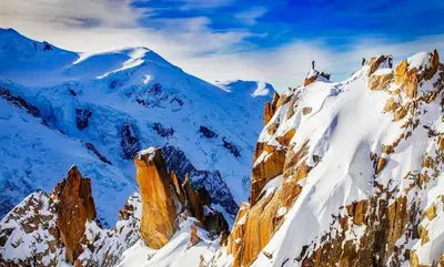 a mountain covered in snow with a person on it at Apartment Grepon 2 - A Chamonix Alpine Haven in Chamonix-Mont-Blanc