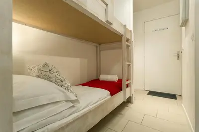 a bedroom with a bunk bed with a red blanket at Apartment Grepon 2 - A Chamonix Alpine Haven in Chamonix-Mont-Blanc