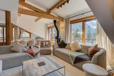 a living room with couches and a table at Les Melées Apartments - Alpes Travel - Argentiere in Chamonix-Mont-Blanc