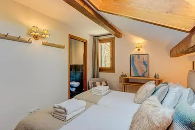 a bedroom with two beds and a desk at Les Melées Apartments - Alpes Travel - Argentiere in Chamonix-Mont-Blanc