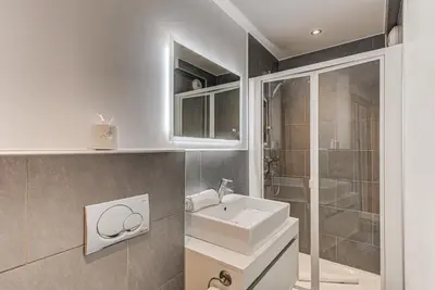 a bathroom with a sink and a shower at Les Melées Apartments - Alpes Travel - Argentiere in Chamonix-Mont-Blanc