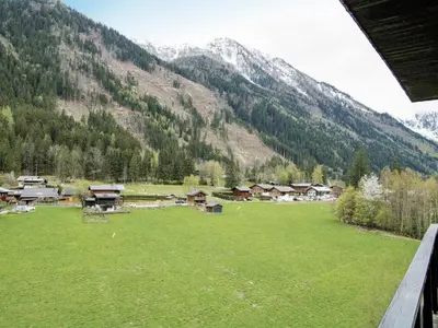 a green field with trees and mountains in the background at Apartment Le Bois du Bouchet-7 by Interhome in Chamonix-Mont-Blanc