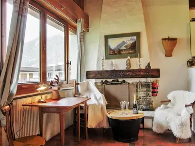 a living room with a couch and a table at Apartment Le Bois du Bouchet-7 by Interhome in Chamonix-Mont-Blanc