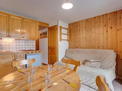 a dining room with a table and chairs and a television at Apartment Aiguille du midi by Interhome in Saint-Gervais-les-Bains