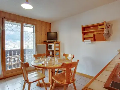 a living room with a table and a couch at Apartment Aiguille du midi by Interhome in Saint-Gervais-les-Bains
